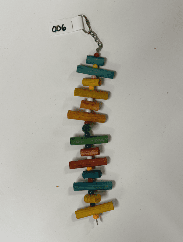 A colorful Little Wood Stacks (Colored) toy hanging from a chain.